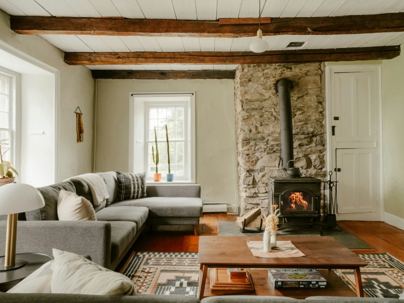 Light-filled open plan living space with wood burner at Hilltop